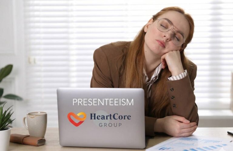 woman sitting in front of laptop looking tired and unwell